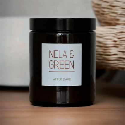 A black jar candle with a label that reads 'NELA & GREEN AFTER DARK'.
